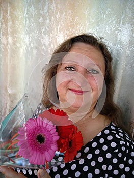 Portrait of a middle-aged woman with a bouquet of flowers