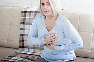 Portrait of middle aged woman having heart attack