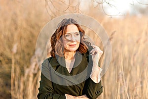 Portrait of middle aged woman posing at the park