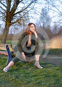 portrait of middle aged woman posing at the park