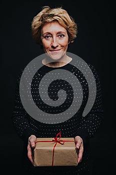 Portrait of middle aged woman with present