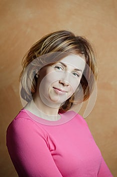 Portrait of middle aged woman with short red hair at home