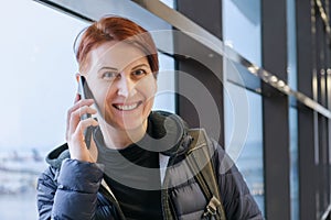 Portrait of middle-aged woman talking on mobile phone