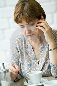 Portrait of a middle-aged woman talking on the phone