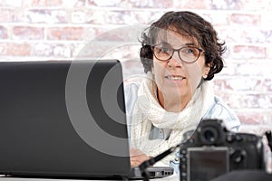 Portrait of middle-aged woman using laptop