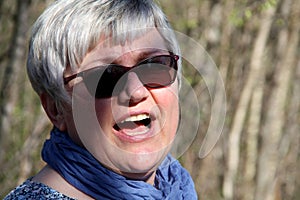 Portrait of a middle-aged woman through the walk in nature talking