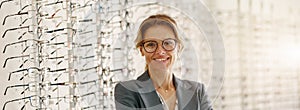 Portrait of middle-aged woman wearing glasses in optical store