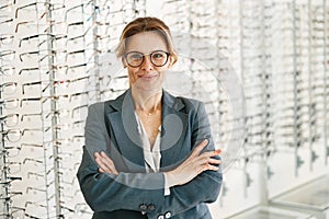 Portrait of middle-aged woman wearing glasses in optical store