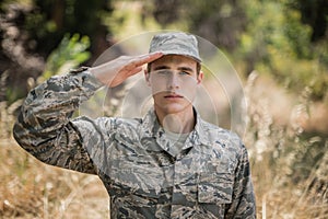 Portrait of military soldier giving salute photo