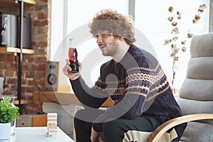 Portrait of millenial boy with retro style, meeting things from the past and having fun, nostalgic the lifestyle of the