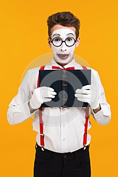 Portrait of mime man artist with book