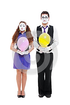 Portrait of mimes with balloons