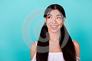 Portrait of minded cheerful girl toothy smile look interested empty space isolated on vibrant emerald color background