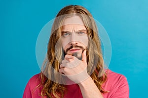 Portrait of minded clever concentrated man sullen eyebrows hand touch chin contemplate isolated on blue color background