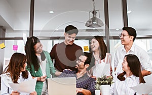 Portrait of mixed race, asian, caucasian business working people wearing casual shirt, smiling with happiness, discussing