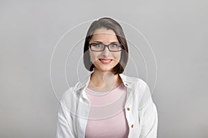 Portrait of mixed race, cheerful, modern, stylish, cute, clever, smiling woman in glasses looking at camera