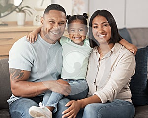 Portrait of a mixed race family of three relaxing on the sofa at home. Loving black family being affectionate on the