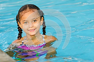 Portrait of mixed race girl in pool