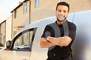 Portrait of mixed race tradesman by a van