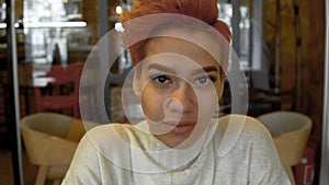 Portrait of mixed race woman posing in public cafe