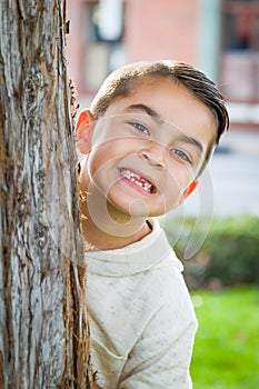 Mixed Race Young Hispanic Caucasian Boy By a Tree