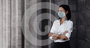 Portrait of a Mixed Races Business Woman, Wearing a Surgical Mask. Healthcare in New Normal Lifestyle Concept. Crossed Arm and