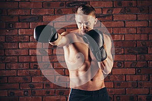 Portrait of mma fighter in boxing pose against brick wall