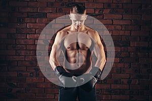 Portrait of mma fighter in boxing pose against brick wall