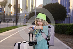 Portrait of modern child boy with luggage, suitcases going on vacations. Kids travel lifestyle. Little boy tourist