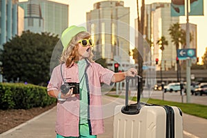 Portrait of modern child boy with luggage, suitcases going on vacations. Kids travel lifestyle. Little boy tourist