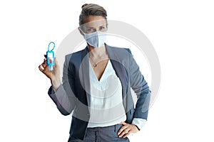 Portrait of modern female in grey suit on showing sanitiser