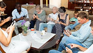 Family absorbedly looking at phones