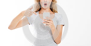 Portrait modern woman pointed at smartphone,seeing bad news or photos with stunned emotion on face open mouth,human reaction