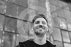 Portrait of Modern Young Person Hipster Guy Standing Alone in Urban Street Covered Colorful Graffiti Alleyway in Black and White