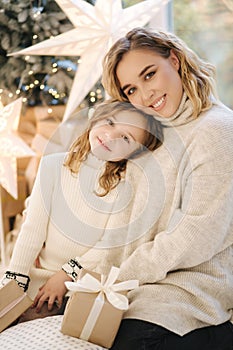 Portrait of mom and daughter in Christmas time. Happy family spent time together during the holiday