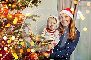 Portrait of mother and boy near Christmas tree