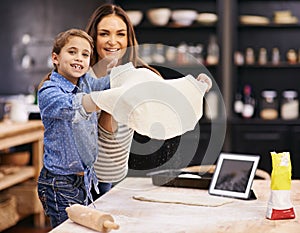 Portrait, mother or child baking pizza in a kitchen teaching recipe for help, support or learning in home. Kid, tablet