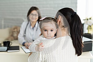 Portrait of mother and child at a doctor`s appointment. Pediatrician meeting with mother and child in hospital