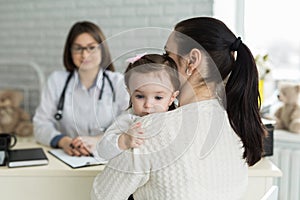 Portrait of mother and child at a doctor's appointment. Pediatrician meeting with mother and child in hospital