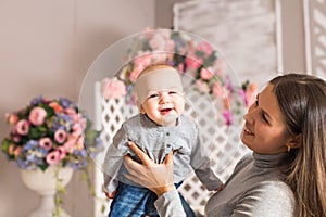 Portrait of mother and child laughing and playing