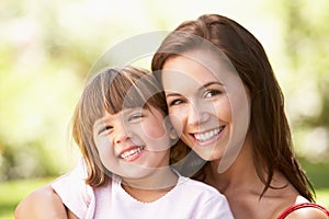 Portrait Of Mother And Child Relaxing In Park