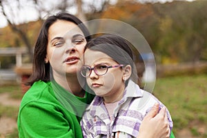 Portrait of a mother and daughter on an autumn day in the park