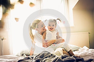 Portrait of Mother and daughter in bed.