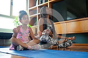 Mother and daughter exercising together at home. photo
