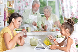 Portrait of mother and daughter having breakfast