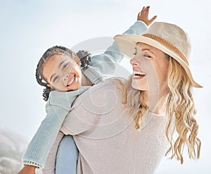 Portrait of a mother and daughter having fun and bonding on a beach vacation together. Happy adopted black child being