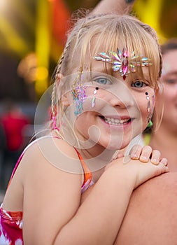 Portrait Of Mother With Daughter Wearing Glitter Having Fun At Outdoor Summer Music Festival 