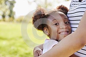 Portrait Of Mother Hugging Daughter In Park