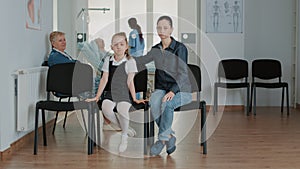 Portrait of mother and little girl in waiting room at clinic