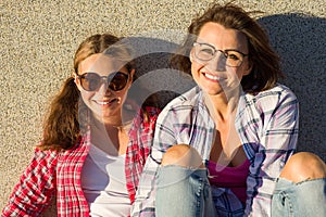 Portrait of mother nd daughter relaxing outdoors